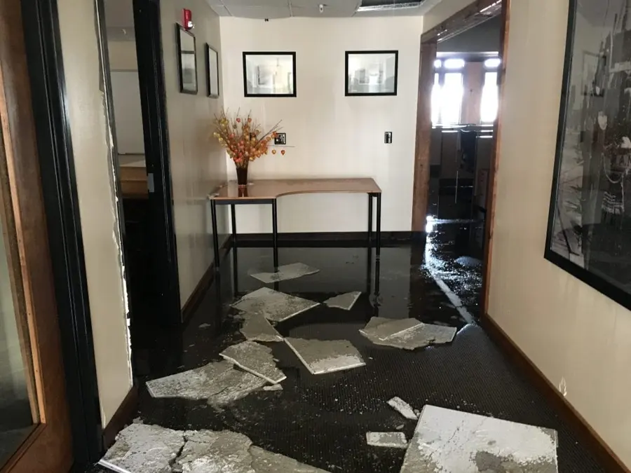 Water across a townhome entry hall with lifted floor tiles in Mission Viejo, CA